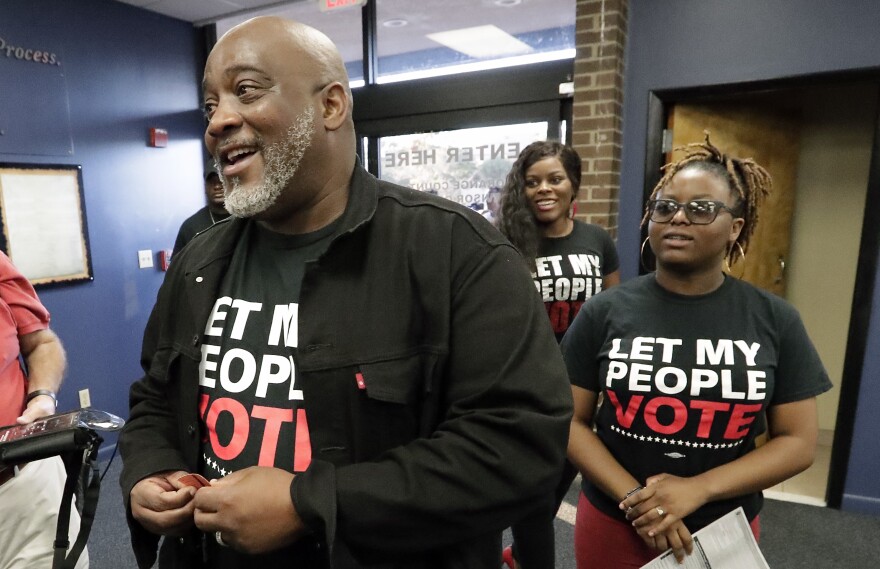 Desmond Meade, president of the Florida Rights Restoration Coalition, arrives with family members at the Supervisor of Elections office in Orlando in January 2019 to register to vote. Meade's group works to restore voting rights to felons.