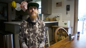 Brian Clark sits at his parent's dining table at their home in Enid. He lost SoonerCare coverage for over a month during the unwinding, an eligibility process states are resuming after a pandemic pause.