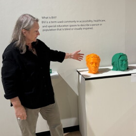 Director of Gallery and Outreach at NKU points to the opening of the exhibit Tactile Revolutions, called Meet the Team.