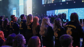 Oklahoma FFA members stand and cheer at the 99th National FFA Convention & Expo in Indianapolis.
