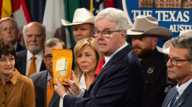 Lt. Gov. Dan Patrick holds a bag of snacks that have THC in them during a media briefing about Senate Bill 3, a bill that would ban all THC products in the state, at the Texas Capitol.