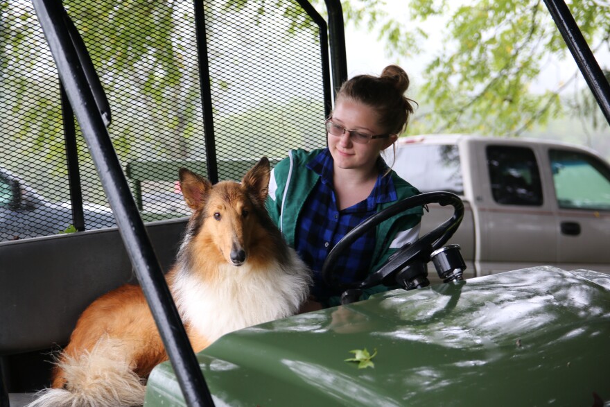 Shelby sits with her family's collie, Sadie. 