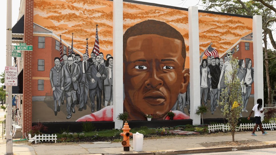 A mural memorializing Baltimore resident Freddie Gray adorns a wall near the place where he was tackled and arrested by police. <em>The Baltimore Sun</em> says it has acquired a copy of the unreleased government autopsy report in the case.