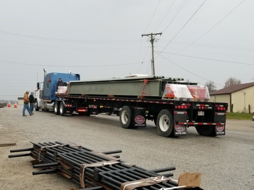 The first steel bridge replacement beams prepare to leave Frankfort, KY.