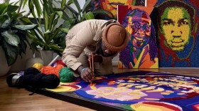 Harold Caudio, known for Skittles portraits of stars like Bob Marley and Janet Jackson, now turns to Warri-Her— a hand-sewn yarn project honoring women's strength, inspired by his mother. The title, a twist on “warrior,” marks a new phase in his empowerment-focused art.