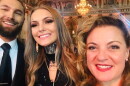 Three people smile into the camera 