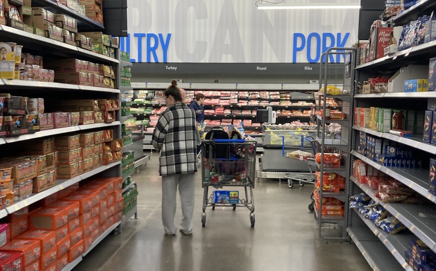 A shopper fills up a cart at a grocery store on Dec. 21.