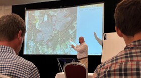 An auctioneer with Hall and Hall starts the bidding for 383 acres of land near downtown Suffolk at the Hilton Garden Inn on May 15.