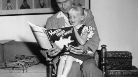 Author and illustrator Theodor Seuss Geisel, known as Dr. Seuss, reads from his book <em>Horton Hears a Who!</em> to 4-year-old Lucinda Bell at his home in La Jolla, Calif., in 1956.
