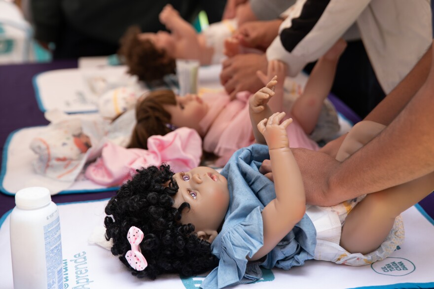 Changing a diaper is one of the fundamental skills that men learn at the Care School.