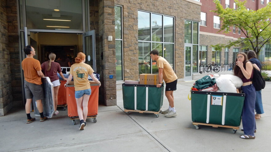Students, parents and volunteers queue up to bring belongings into dorm rooms at UVM's Central Campus Residence Hall