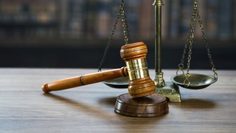 Law and Justice concept. Mallet of the judge, books, scales of justice. Courtroom theme.