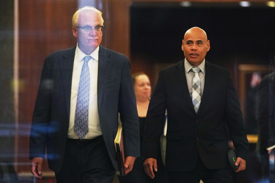 Christian Castro, right, an immigration officer who is accused of shooting a Venezuelan man during the immigration crackdown in Minneapolis early this year and lying to investigators about what happened, leaves with his attorney Daniel Gerdts, left, after a hearing at the Warren E. Burger Federal Building, Friday, Sept. 18, 2026, in St. Paul, Minn.