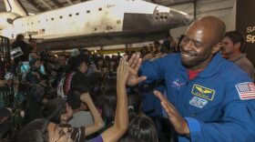 NASA astronaut Leland Melvin greets school children for the opening of the Space Shuttle Endeavor at the Oschin pavilion at the California Science Center in Los Angeles in 2012. (Damian Dovarganes/AP)