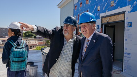 Real estate developer Lee Peyser shows Rhode Island Gov. Dan McKee construction at Dexter Street Commons in Pawtucket.
