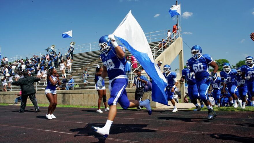 FILE: In this 2015 photo, Senior Christian Sanchez carries the flag for the Cheyney University football team (Photo: Bastiaan Slabbers/WHYY)