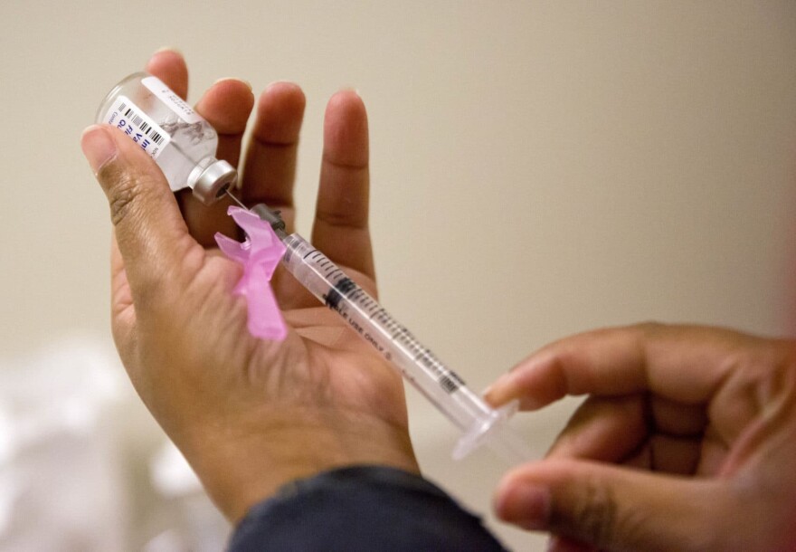 A nurse prepares a flu shot at the Salvation Army in Atlanta. (David Goldman/AP)