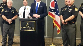 Congressman Mike Turner (R-10) is flanked by Montgomery County Sheriff Phil Plummer (left), Green County Sheriff Gene Fischer (right) and other law enforcement officials at a press conference at WPAFB.