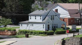 A Richmond street slopes downward toward University Drive. Two people drowned in the basement of the residence at the bottom after a flash flood submerged the property on June 27.