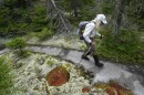 FILE - M.J. Eberhart, 83, carefully hikes the Appalachian Trail, Sept. 12, 2021, in Gorham, New Hampshire. (AP Photo/Robert F. Bukaty, File)