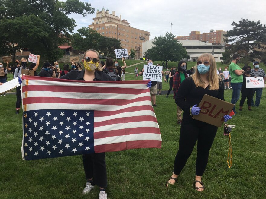 Ingrid Weaver, 19, of KC, says she’s holding the US flag upside down because it’s a sign of distress. She said it’s time for change in America.