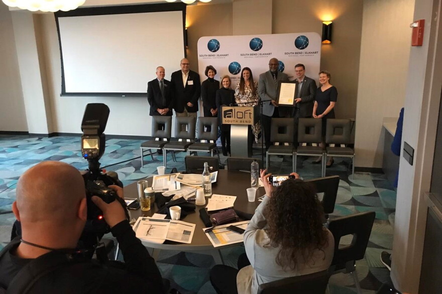Local and state leaders in workforce and education pose with a "21st Century Talent Region" proclamation issued by Gov. Eric Holcomb.