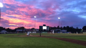 A baseball field at sunset.