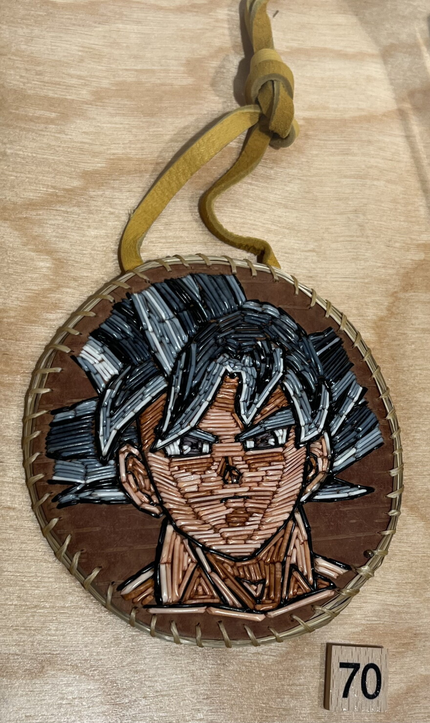 Quill art medallion depicting Goku from Dragon Ball Z