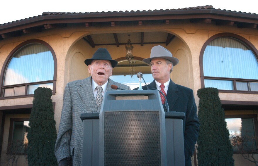 In this Tuesday, Dec. 21, 2004 file photo, Idaho Gov. Dirk Kempthorne, right, stands next to potato magnate J.R. Simplot, at Simplot's home in Boise, Idaho. 
