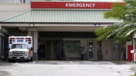 An ambulance is parked outside the emergency room at The Queen's Medical Center in Honolulu, Tuesday, Aug. 24, 2021.