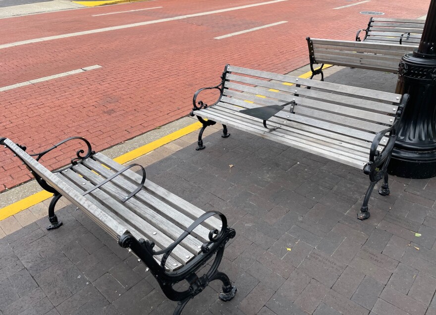 Two of the benches with arm rests and trays that remain on Main St.