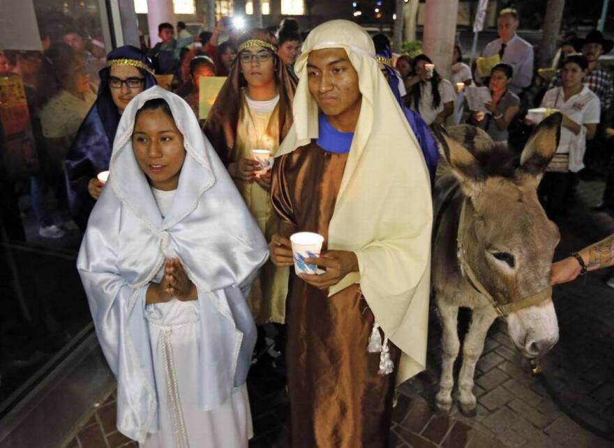 Mari Marquez and Marshall Soto play Mary and Joseph during the traditional Posada procession in Homestead in December 2015.