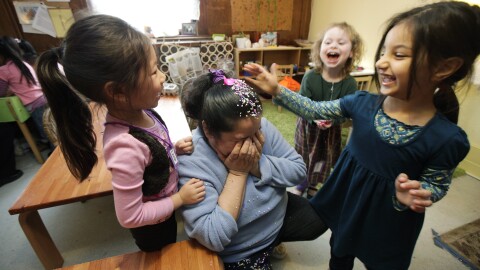 Preschool students smash an egg filled with confetti on their teacher's head. 