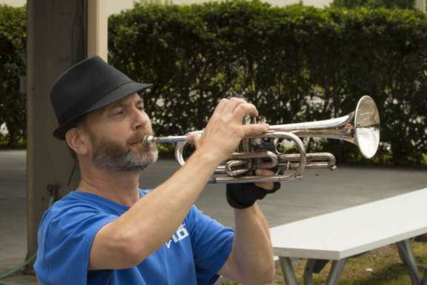 Trumpeter Tom Losce performs Taps. Photo: Mike Abendschein