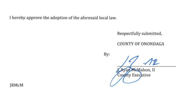A portion of the document signed by County Executive Ryan McMahon in error, approving a term limits law he intended to veto.