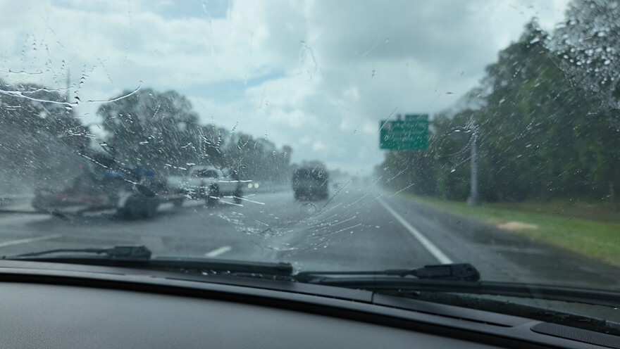 Rain hits the windshield of a car driving down I-75 in Alachua County.