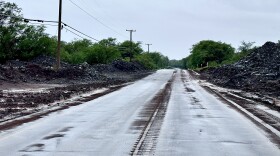 Towering piles of rocks and mud washed down onto the road from the mountains are more than 15 feet high along Kamehameha V Highway on Molokaʻi in the aftermath of last weekend's storm.