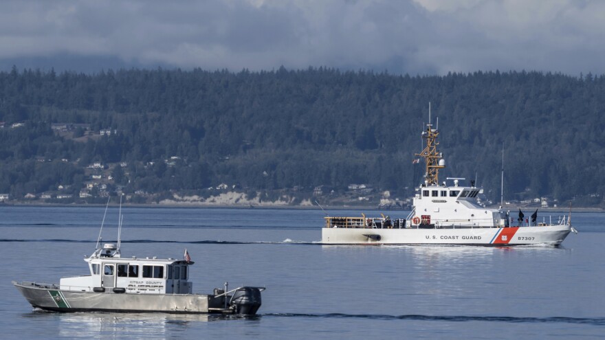 FILE - A U.S. Coast Guard boat and Kitsap, Wash., County Sheriff's Office boat search the area near Freeland, Wash., on Whidbey Island north of Seattle, Monday, Sept. 5, 2022, where a chartered floatplane crashed the day before, killing 10 people. The Federal Aviation Administration has issued an emergency airworthiness directive about a part of the tail of DHC-3 Otters, the type of seaplane that crashed.