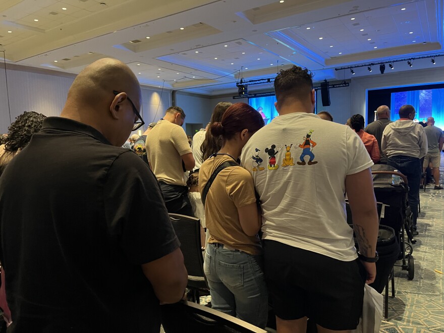 FPEA participants stand for a moment of silence and prayer at the start of the conference.