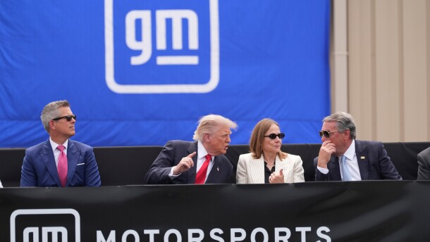 President Donald Trump, center left, speaks with Mary Barra, chair and CEO of General Motors, center right, and General Motors President Mark Reuss, right, as Transportation Secretary Sean Duffy listens at left, during a driving demonstration at General Motors proving ground, Monday, July 27, 2026, in Milford, Mich. (AP Photo/Alex Brandon)