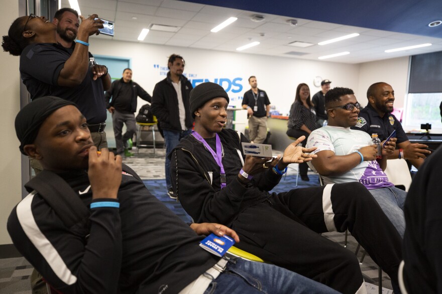 Jawan Coleman (center) asks a question during the Juvenile Justice Jeopardy workshop.