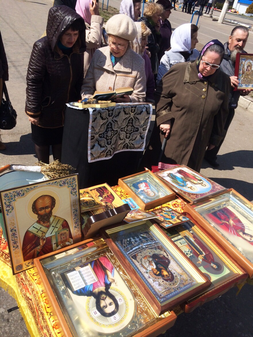 Women outside the occupied building in Luhansk pray "that we will join Russia."