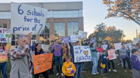Parents and community members protest outside of a Lakewood Board of Education meeting Monday at Lakewood High School, concerned with an upcoming vote on consolidating the district's elementary schools.