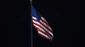 An American flag flies over Comerica Park in the ninth inning of a baseball game between the Detroit Tigers and San Francisco Giants in Detroit, Tuesday, Aug. 23, 2022. (AP Photo/Paul Sancya)