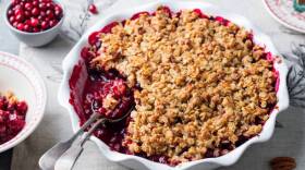 Cranberry crumble, crisp in a baking dish. Grey background. Close up