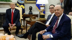 President Donald Trump sits with Secretary of Commerce Wilbur Ross, right, and Treasury Secretary Steve Mnuchin, center, during a meeting with European Commission president Jean-Claude Juncker in the Oval Office of the White House, Wednesday, July 25, 2018, in Washington. National security adviser John Bolton listens at top right. (Evan Vucci/AP)
