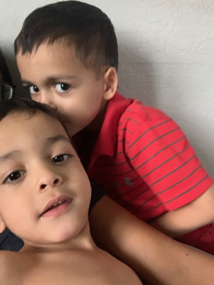 Kaiden Pierce, 5, kisses his younger brother, 3-year-old Greyson Pierce. Greyson has a developmental disability and can't talk to his brother.