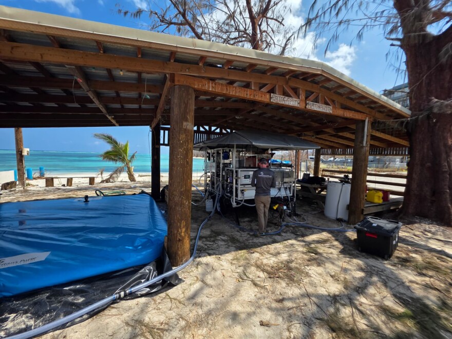 Brent Kejr, water, sanitation and hygiene (WASH) technical adviser and manager of emergency water response for Samaritan's Purse, is testing one of the desalination systems that convert sea water to fresh water at Sugar Dock.