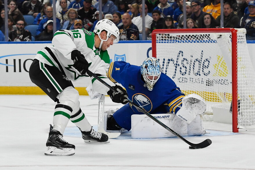Dallas Stars right wing Mikko Rantanen, left, skates the puck in against Buffalo Sabres goalie Ukko-Pekka Luukkonen, right, during the second period of an NHL hockey game Thursday, Oct. 8, 2026, in Buffalo, N.Y. (AP Photo/Adrian Kraus)
