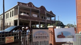 Men in hard hats gather near a truck outside of the Sanchez y Haya building moments after a ceremonial groundbreaking ceremony for the restoration project on Nov. 25. 